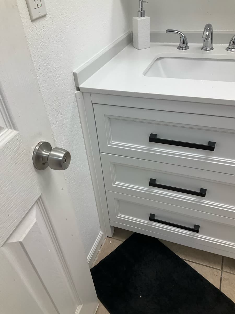 black drawer pulls on white bathroom vanity